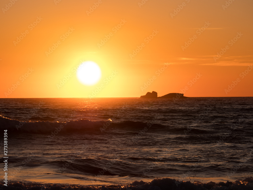 Soft golden light reflected on ocean at sunset