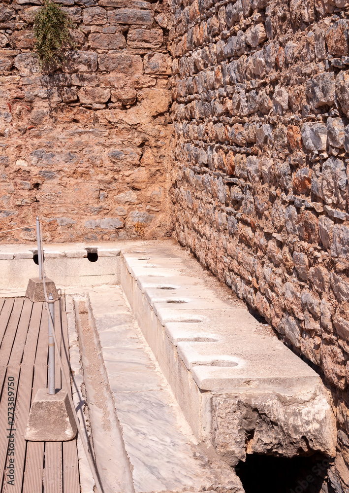 Public toilet in the ancient city of Ephesus in Izmir, Turkey. Public toilet in the ancient city of Ephesus in Izmir, Turkey.
