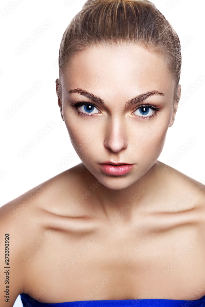 Fototapeta premium Portrait of young beautiful girl with long blond hair and natural make-up