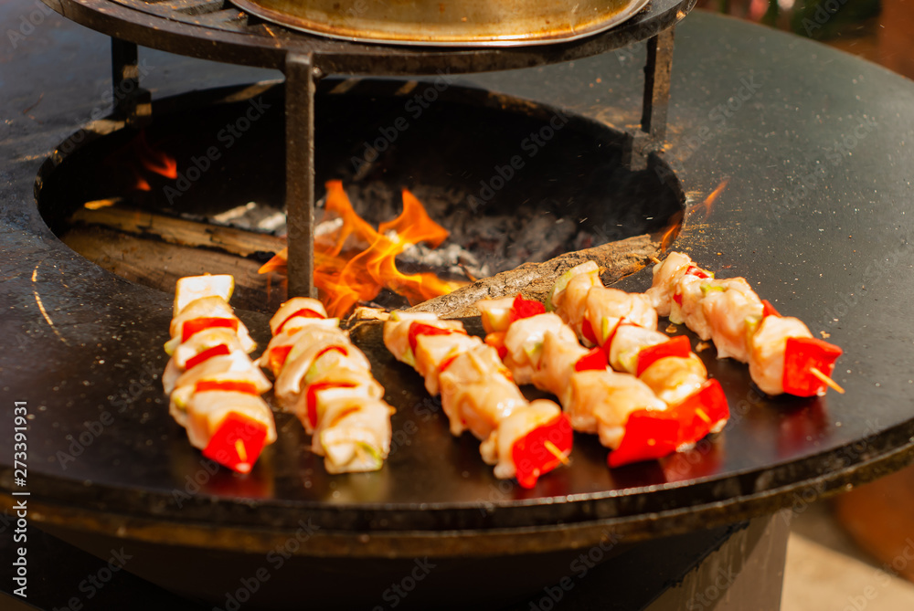 small satay on wooden skewers fried on a brazier close up small satay on wooden skewers fried on a brazier close up