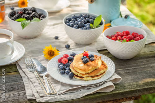 Tasty pancakes for breakfast in summer garden