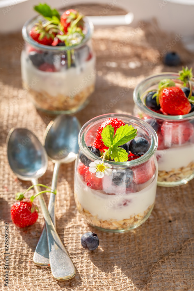 Oat flakes in jar with yoghurt and berries Oat flakes in jar with yoghurt and berries