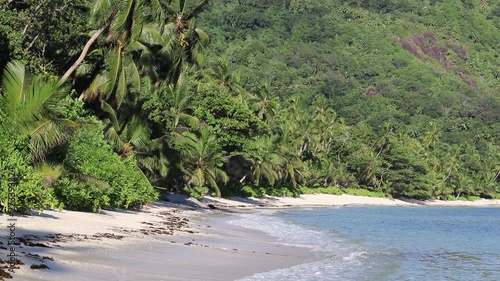 Beautiful view at the beaches of the Seychelles with some splahing water waves and a blue sky photo