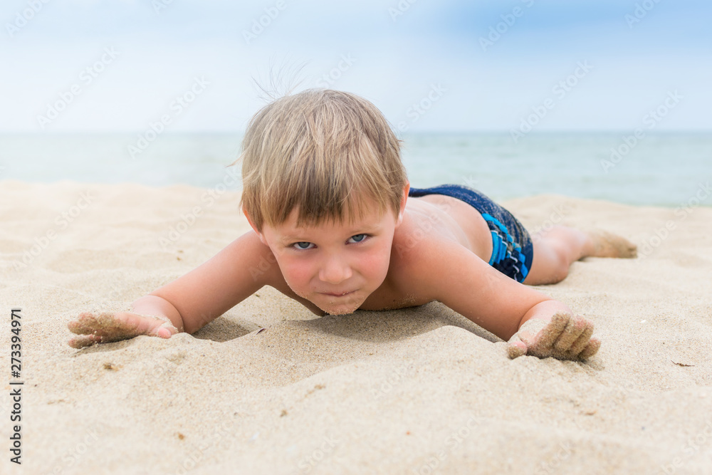 A little boy is having fun on the beach. Rest of the child on the sea, ocean. A little boy is having fun on the beach. Rest of the child on the sea, ocean.