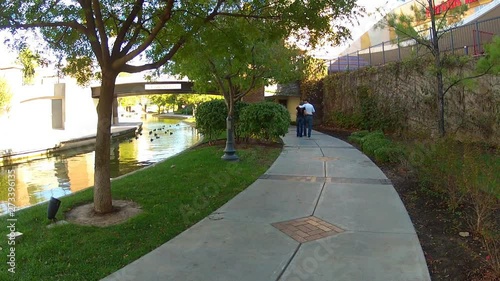 Couple Walking Riverwalk in Oklahoma City Oklahoma photo