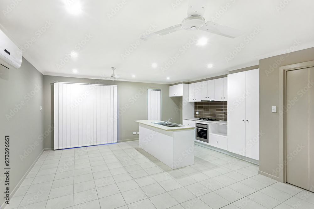 Fototapeta premium Fully-furnished modular kitchen with white interiors
