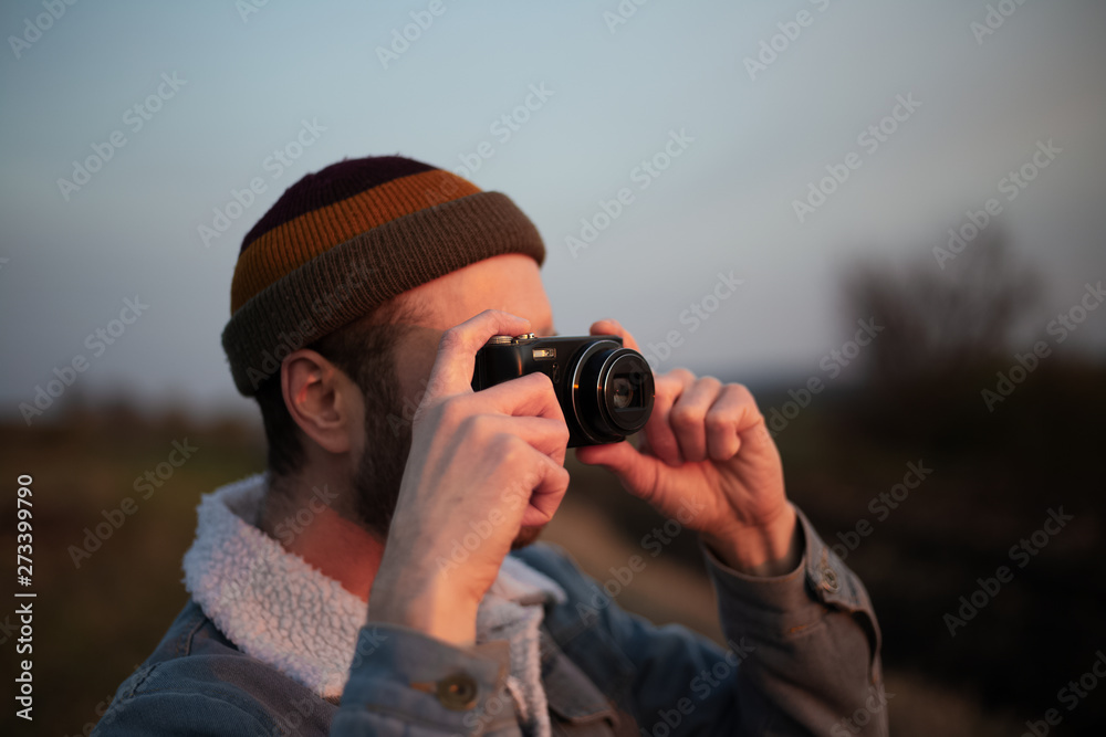 Close-up portrait of young guy taking photo by digital camera Close-up portrait of young guy taking photo by digital camera
