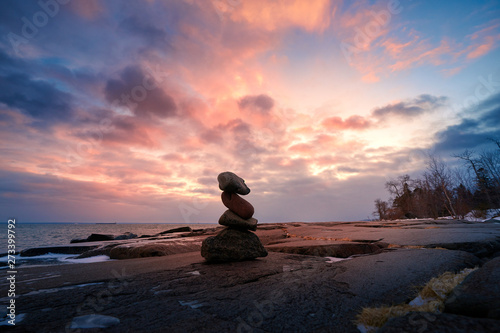 Zen Stone Stacking on rocks during sunset