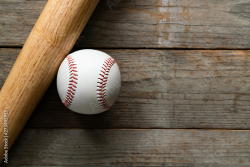 baseball and baseball bat on wooden table background