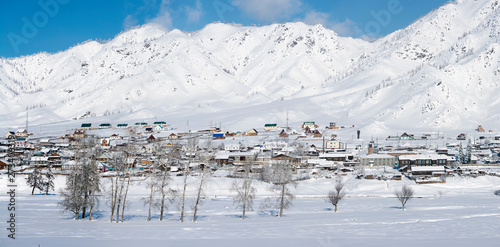 Winter rural landscape in Siberia. The village in the Altai mountains. HDR - high dynamic range.