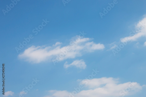 Blue sky with soft white clouds.
