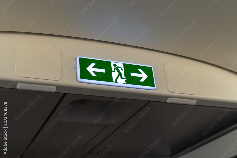 Exit lightbox signage on airplane, escape way of life. way to survive concept Exit lightbox signage on airplane, escape way of life. way to survive concept