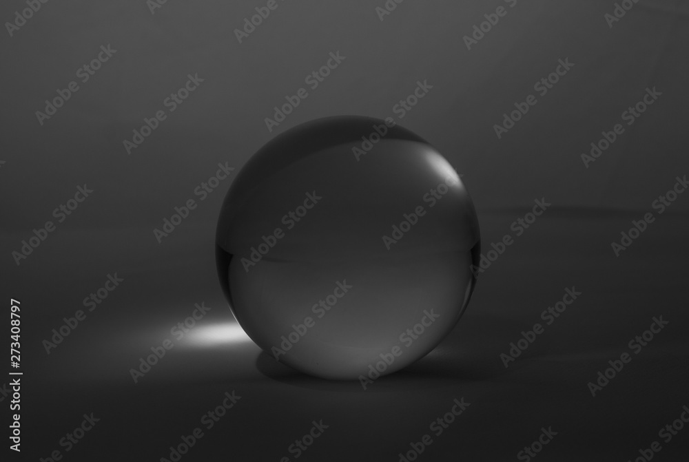 Crystal glass ball sphere transparent on dark grey gradient background. Crystal glass ball sphere transparent on dark grey gradient background.