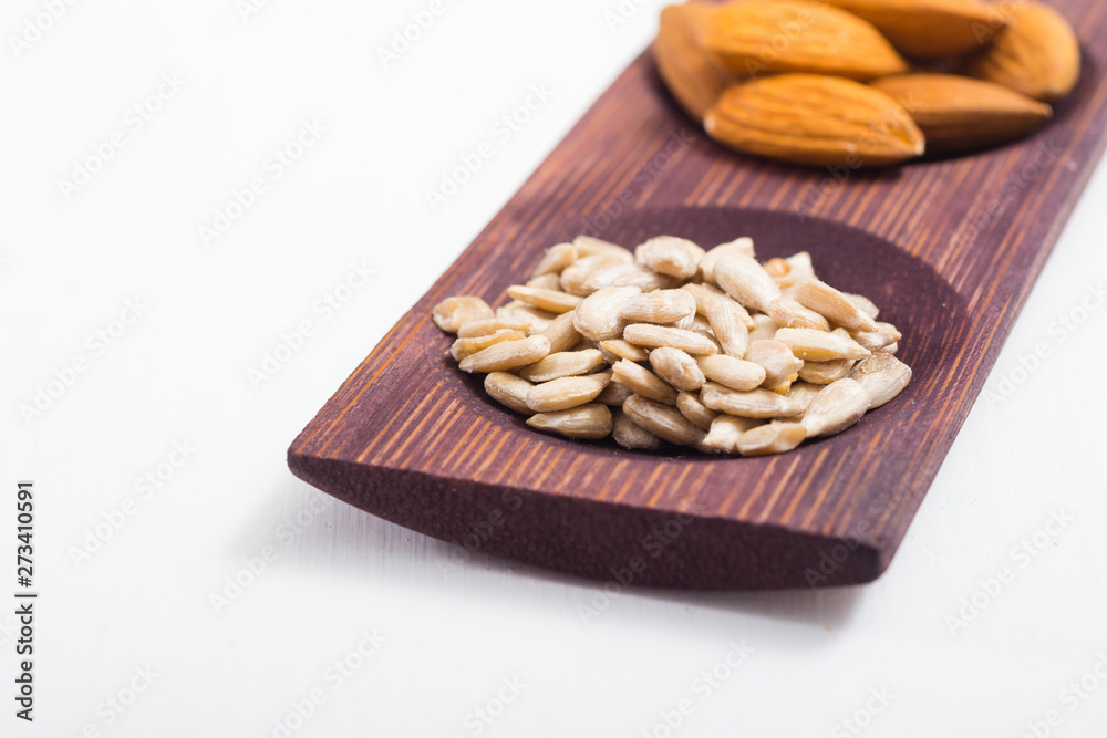 dried fruits and spices on wooden tray, white table dried fruits and spices on wooden tray, white table