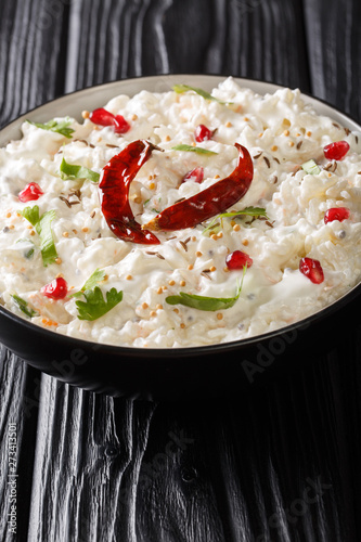 Curd Rice or Perugu Annam recipe is a perfect amalgamation of mild southern spices and sweet-tangy flavours of curd closeup in a plate. Vertical photo