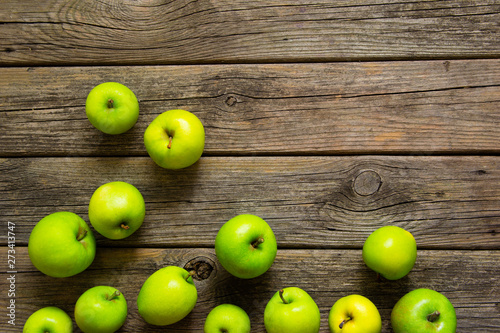 green apples on old wooden background