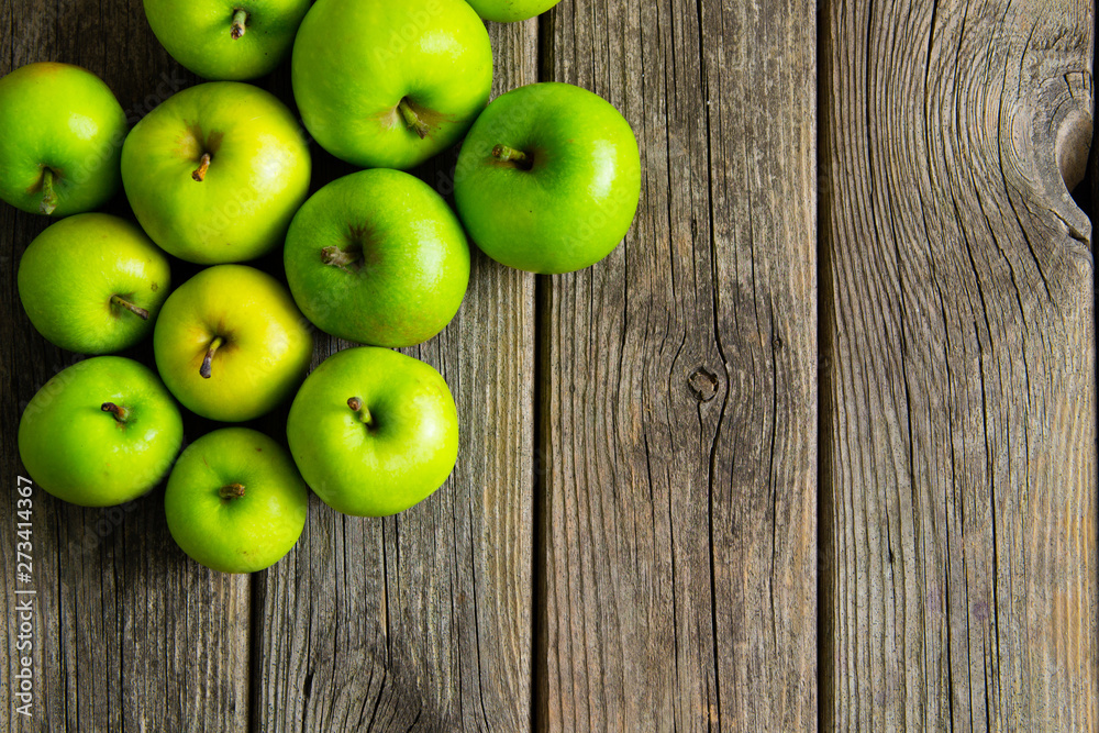 green apples on old wooden background green apples on old wooden background