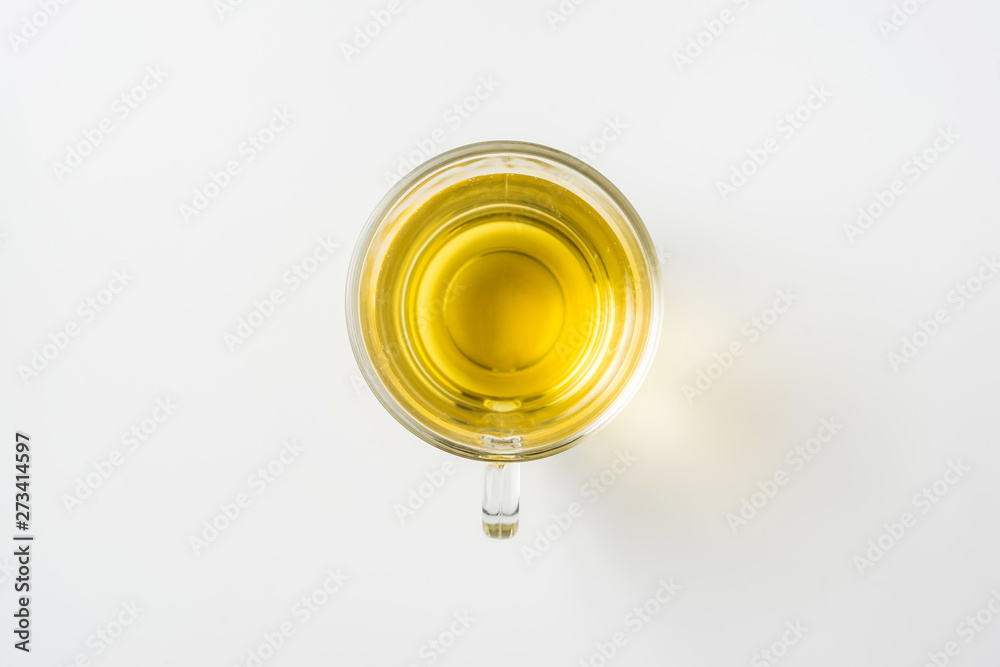 Top view of glass cup of hot tea on white background
