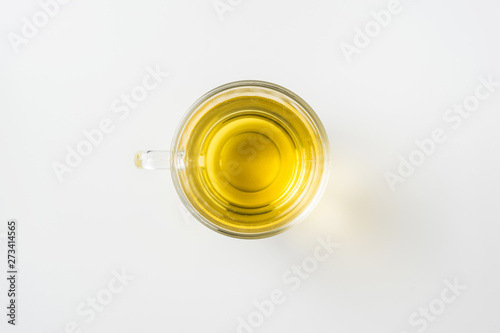 Top view of glass cup of hot tea on white background