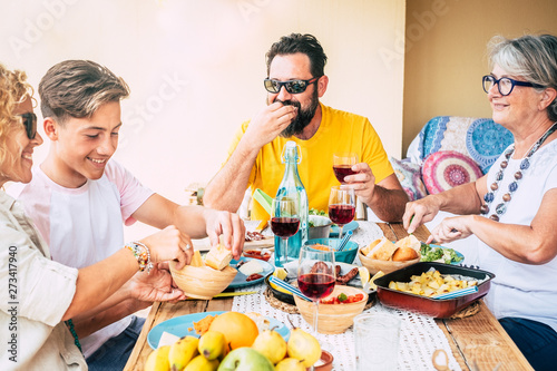 Bbq time on the wooden rustic table. Family with parents  son and grandma having joy together. Bright background. Focus on father black hair