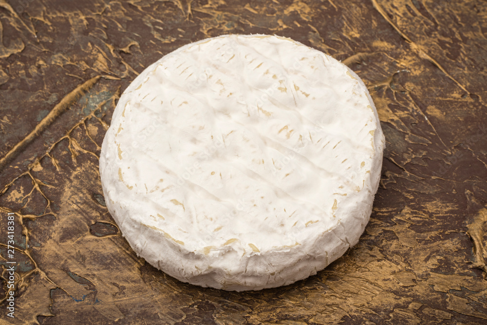 Camembert cheese on a textural table. Snack to wine. closeup Camembert cheese on a textural table. Snack to wine. closeup