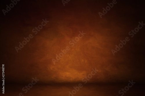 Photo background is orange red. textured wall rolling in the floor. studio photography background illuminated by the directed light. Traditional painted canvas or muslin fabric cloth studio backdrop