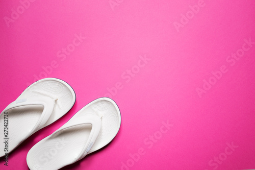 Flip flops on a pink isolated background. White female flip flops.