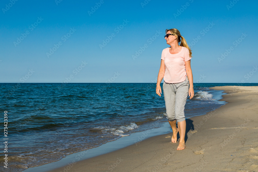 Woman waking on beach