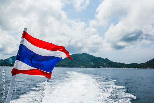 flag of Thailand on a ship in the sea, flag on a ferry with clear sky and deep blue sea background