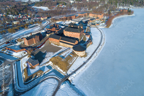 Above the ancient fortress of the Hameenlinna city on a sunny March day (aerial photography). Finland