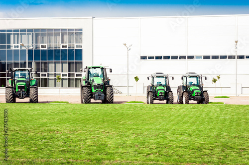 new tractors are standing next to the trading pavilion for sale in Kiev region, Ukraine.