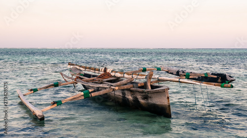 Mokoro boat on sea shore 