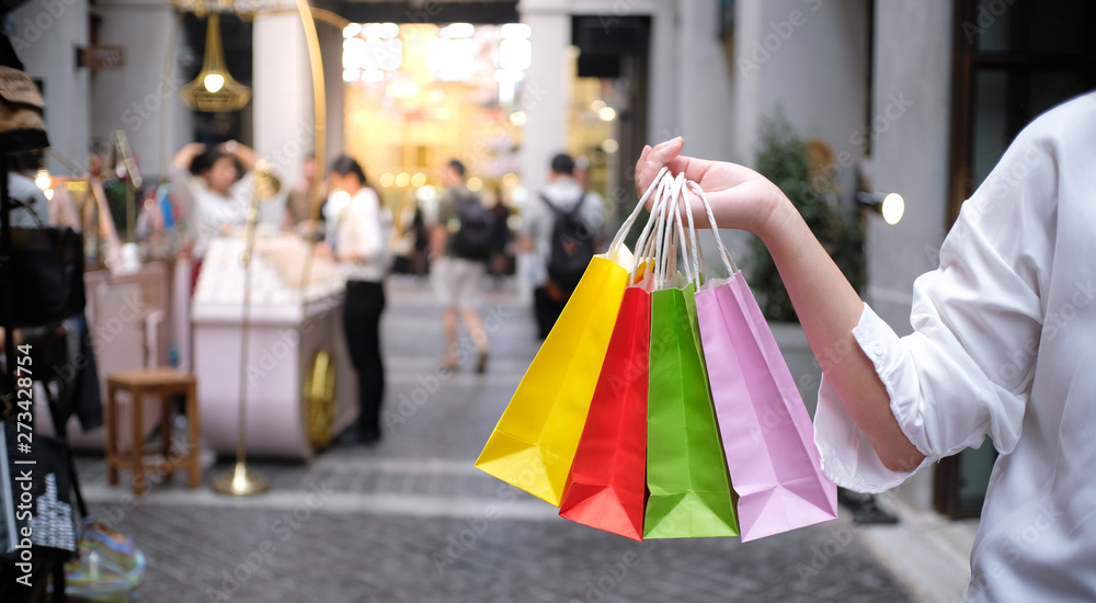 Asian girls holding sale shopping bags. consumerism lifestyle concept in the shopping mall. Asian girls holding sale shopping bags. consumerism lifestyle concept in the shopping mall.