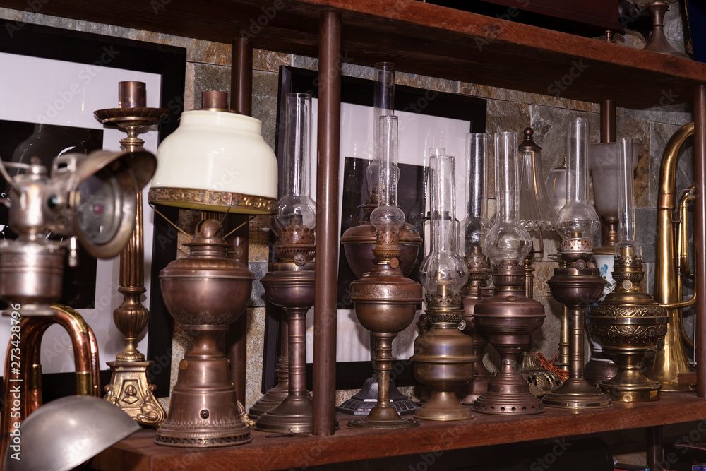 Many kind of colorful lamps on wooden shelf, the paraffin lamp or hand