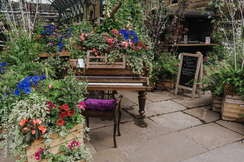 Photography Beautiful piano decorated with flowers at Covent Garden, London