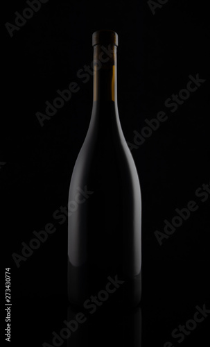 Isolated black matt wine bottle on dark background