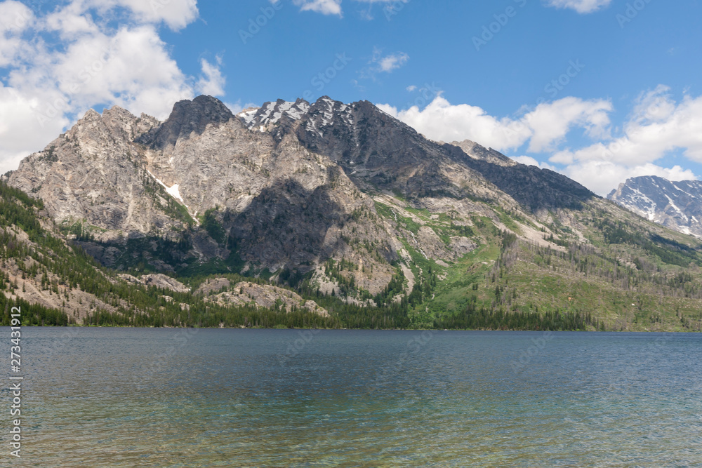 A fresh water lake in Montana with blue sky and clouds.