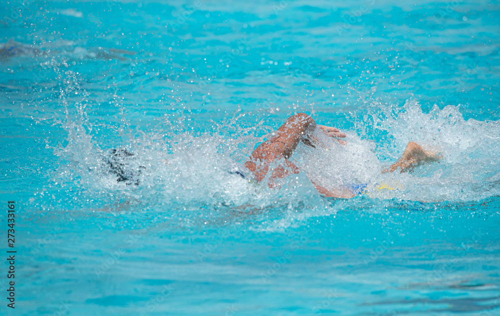 Athletes swimming on a swimming-pool