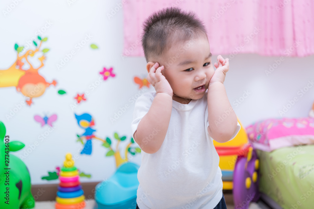 Asian portrait cute child boy and there are toys on back
