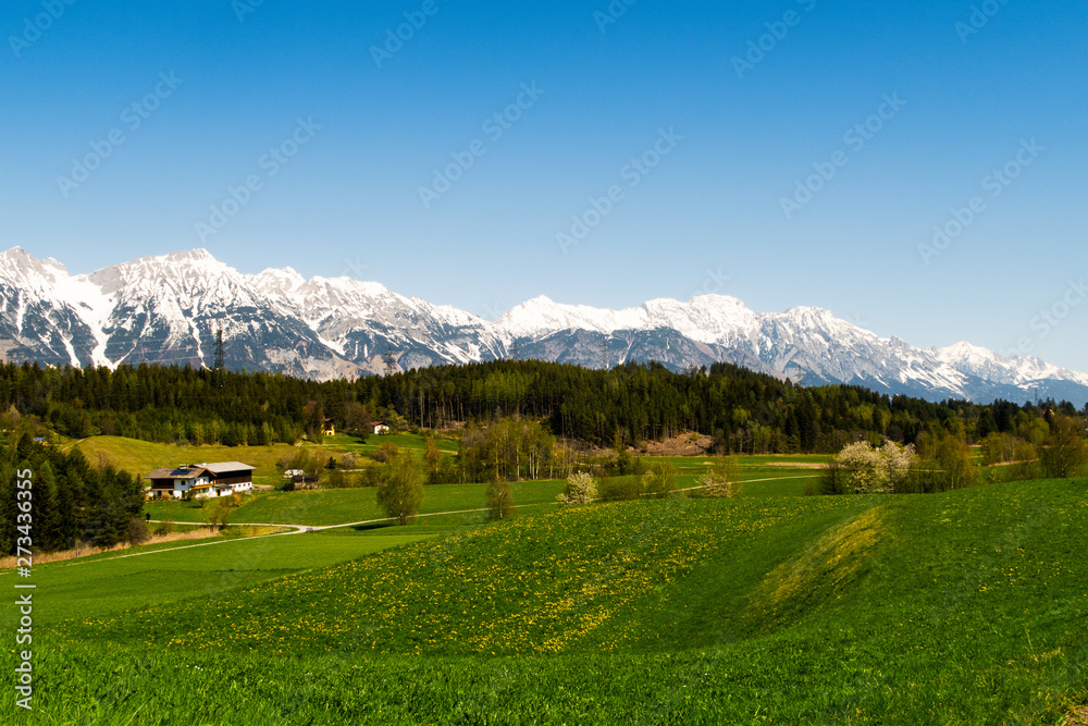 Field view from Lans Dorf in Innsbruck Austria with the Alps in the background