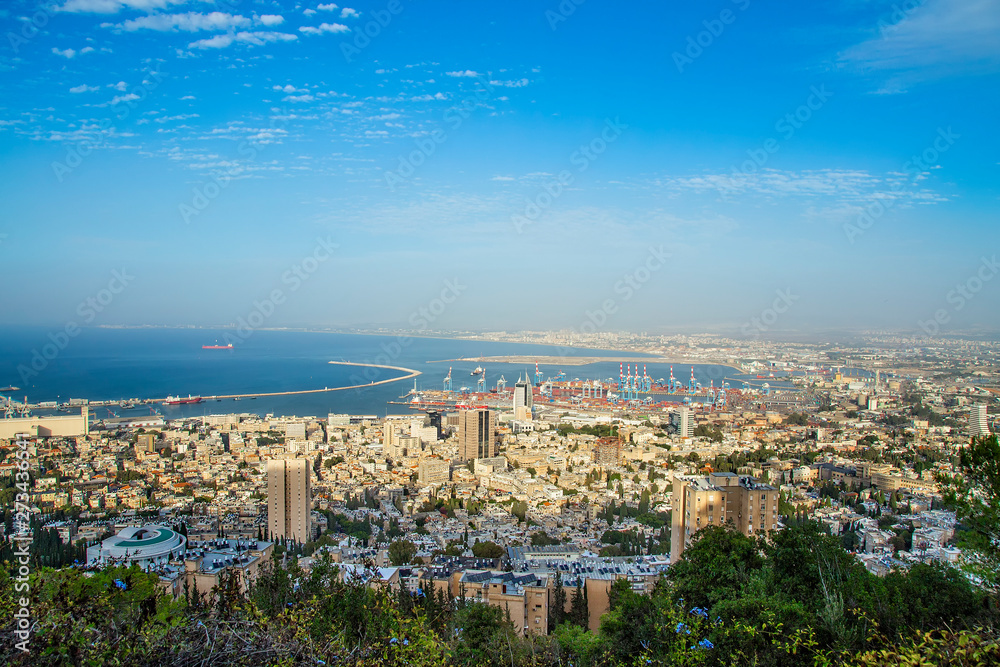 Panoramic view of the harbor port of Haifa, with downtown Haifa, the harbor, the industrial zone in a sunny summer day. Haifa, Northern Israel Panoramic view of the harbor port of Haifa, with downtown Haifa, the harbor, the industrial zone in a sunny summer day. Haifa, Northern Israel