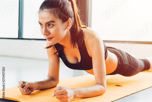 Beautiful woman exercise workout with planking on mat