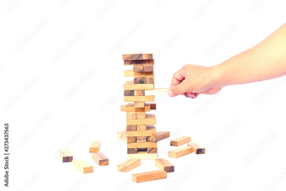 hand of businessman pulling out or placing wood block on the tower in modern office. plan and strategy in business. blur for background hand of businessman pulling out or placing wood block on the tower in modern office. plan and strategy in business. blur for background
