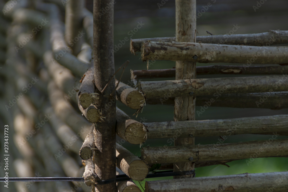 Close-up of the fence of a country farm of wooden poles Close-up of the fence of a country farm of wooden poles