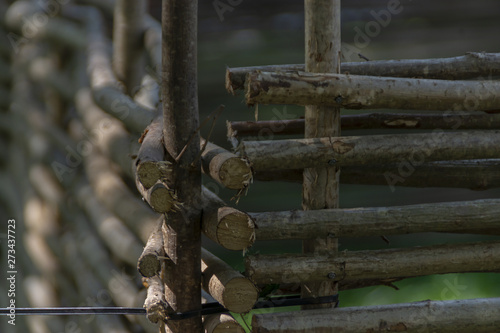 Close-up of the fence of a country farm of wooden poles