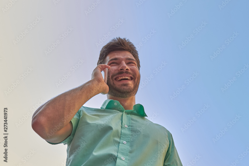 Fototapeta premium Good looking man using smartphone on the street.