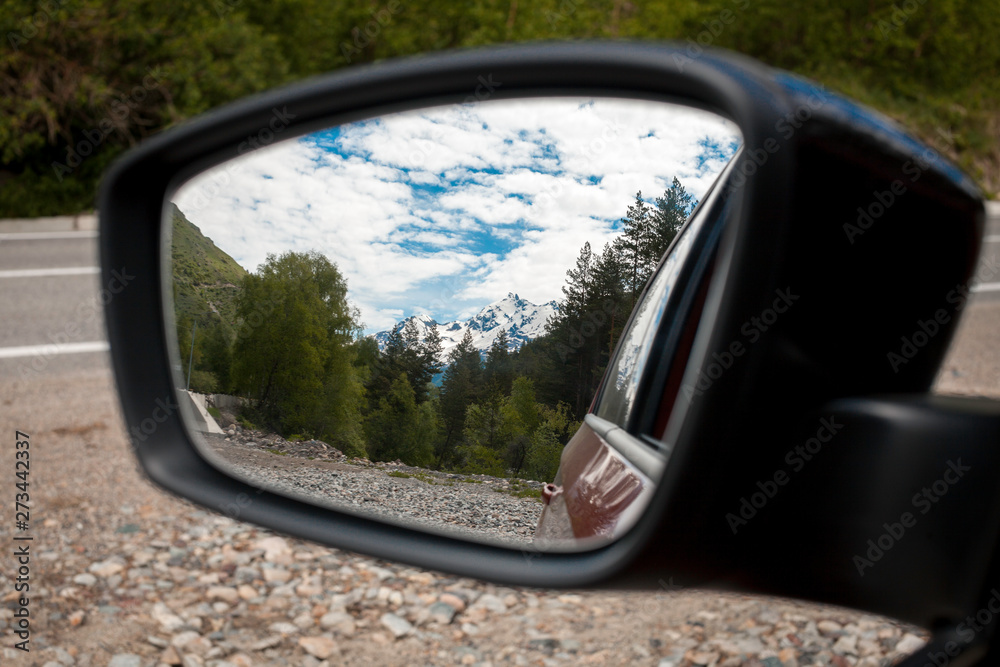 Beautiful mountains seen on the rearview mirror.