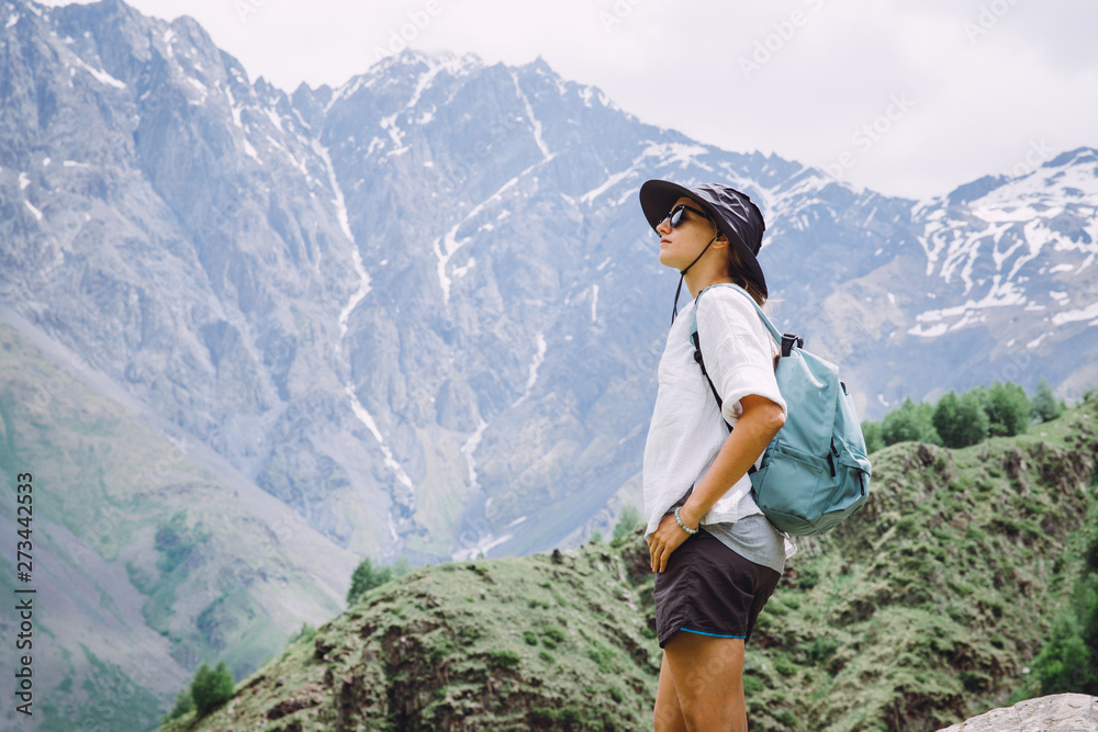 Young woman tourist admiring mountains in  in Georgia