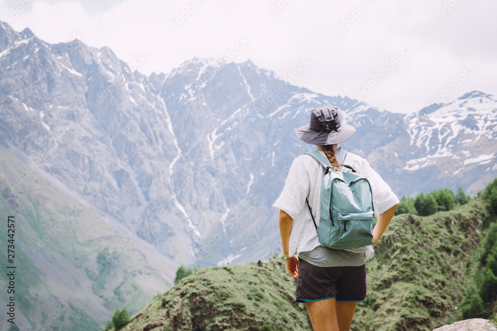 Young woman tourist admiring mountains in  in Georgia