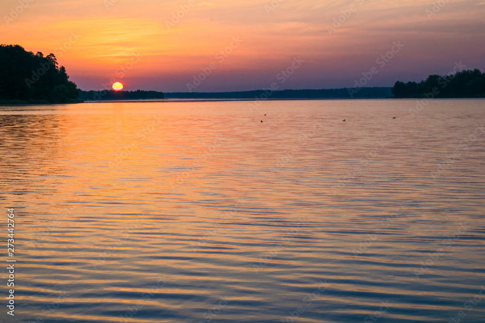 Fototapeta premium Sunrises sunsets on a summer pond in the forest